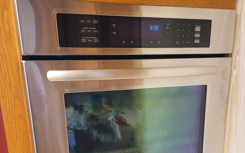 Technician repairing oven with heating and temperature issues in Plano TX
