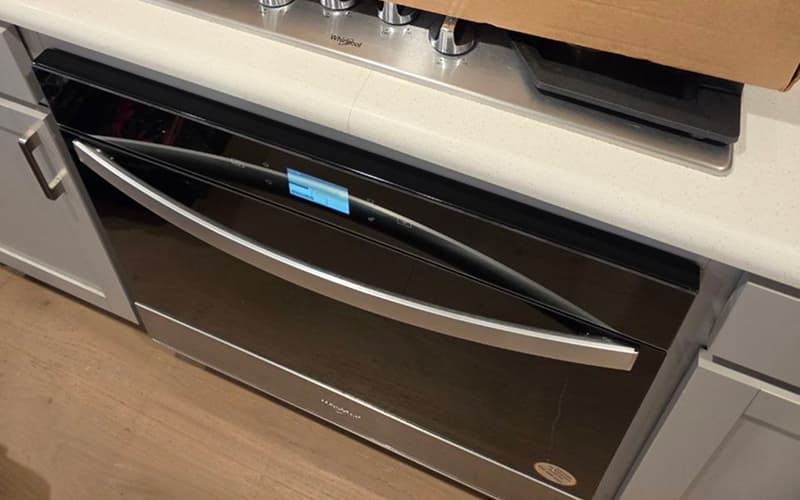 Oven Not Heating Properly? Common Problems and Professional Repair in Plano, TX Technician repairing oven with heating and temperature issues in Plano TX